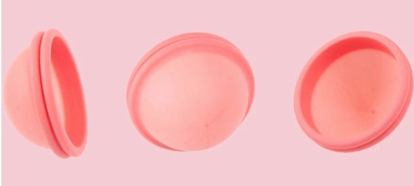 Photo of 3 silicone menstrual discs from different angles