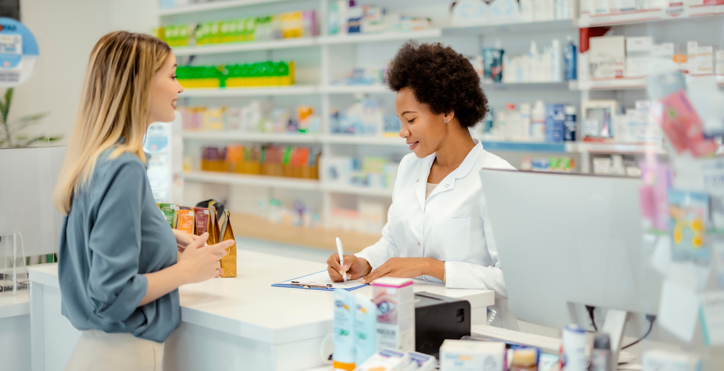 Photo of a woman talking to a pharmacist