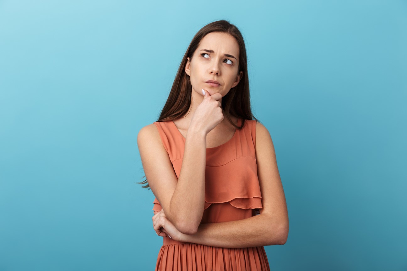Photo of a woman in a thoughtful pose on a blue background