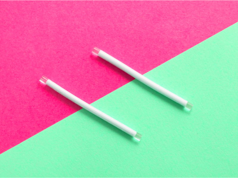 Photo of 2 implants across a pink and green background