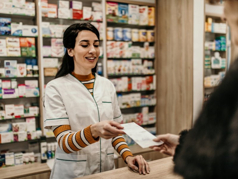 Photo of a pharmacist being handed a script