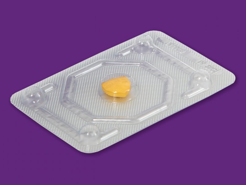 Photo of a single pill packet on a purple background