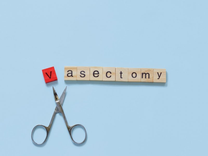 Photo of scrabble tiles spelling 'vasectomy' with a pair of scissors