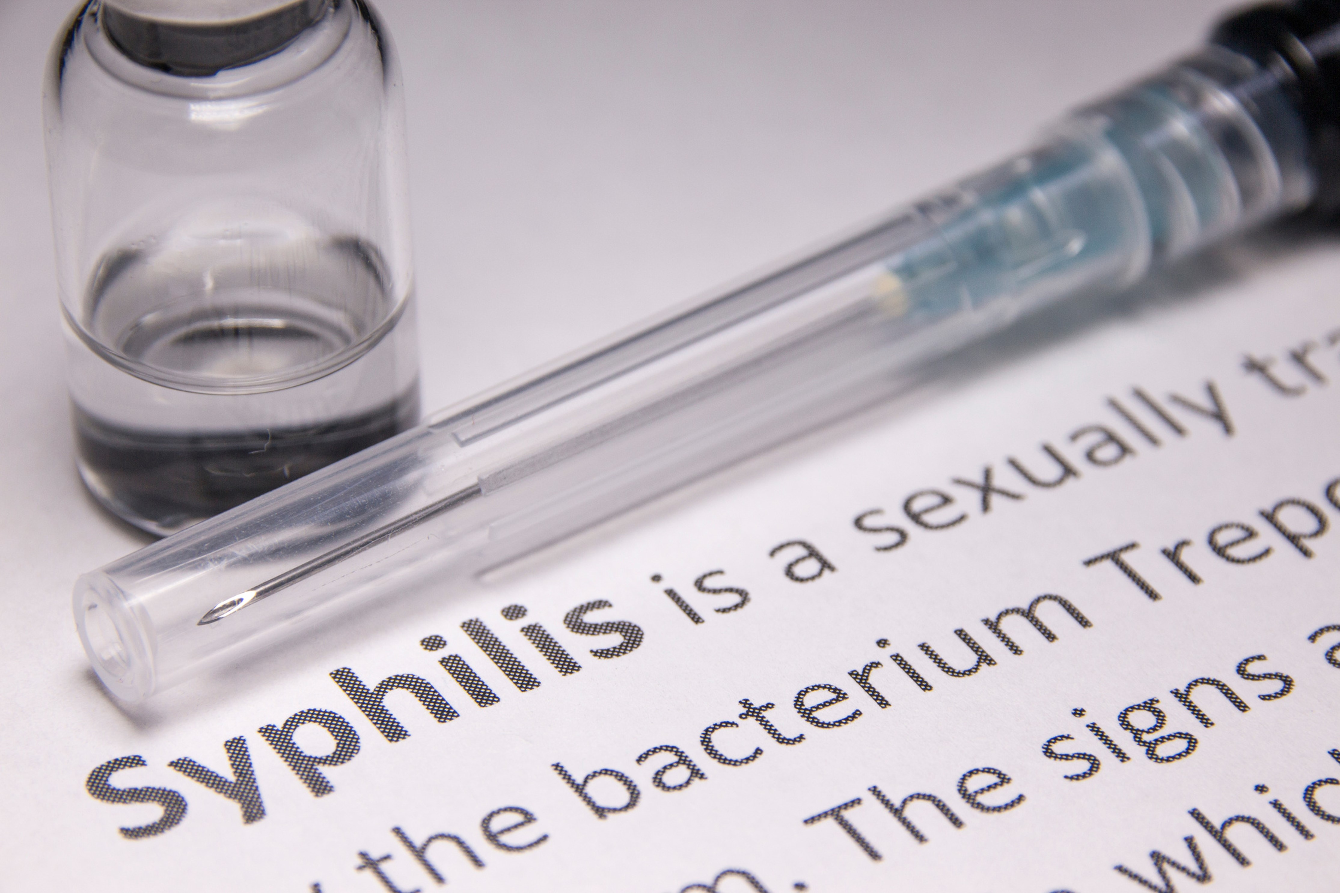 Photo of glass vial and text saying 'Syphilis'
